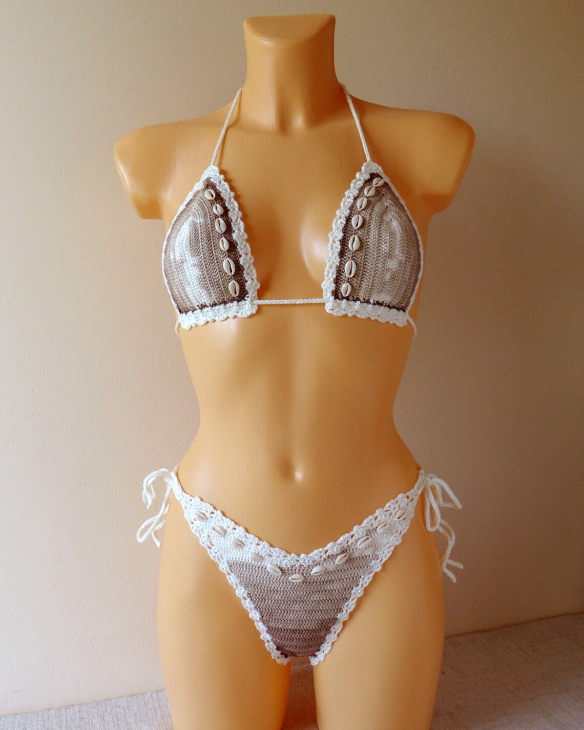 Lace bikini set with seashells on a mannequin 