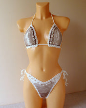 Lace bikini set with seashells on a mannequin 