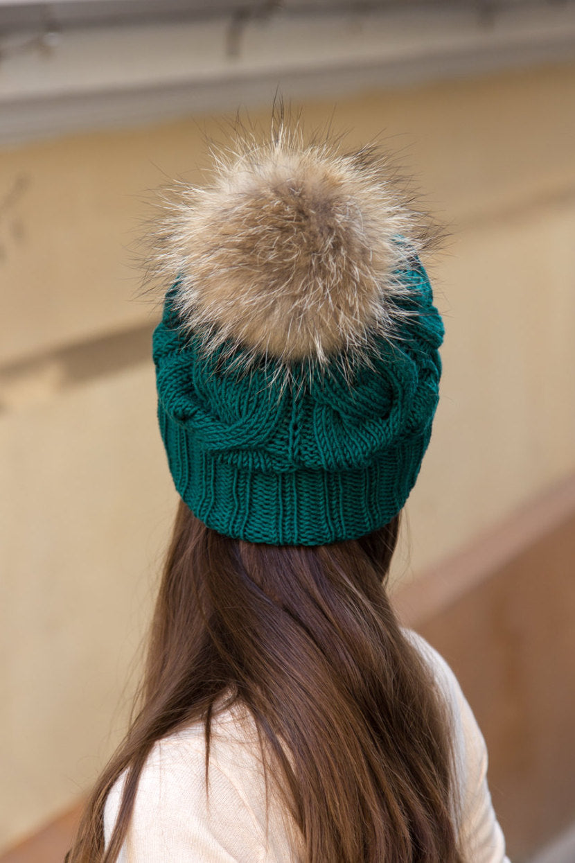knitted beanie with brown fur pom pom