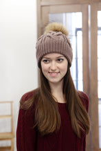 brown hand knitted hat with fur pom pom